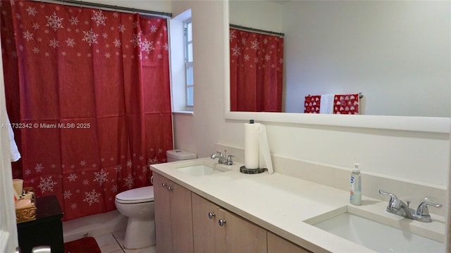 bathroom with tile patterned flooring, vanity, and toilet