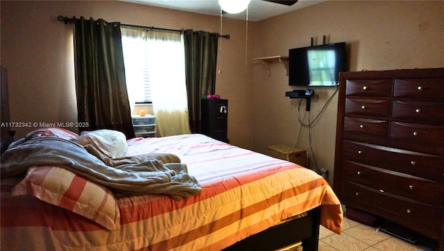 tiled bedroom featuring ceiling fan