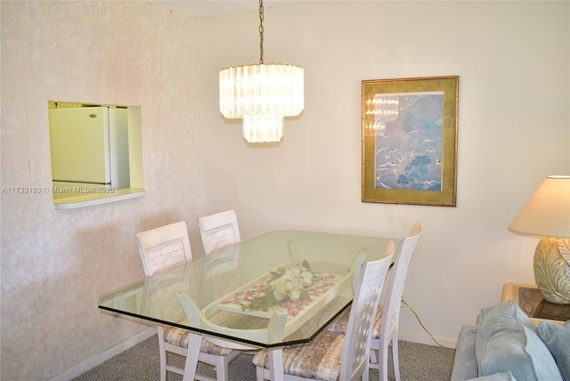 carpeted dining area with a notable chandelier