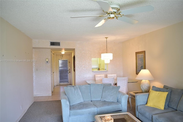 9360 Sunrise Lakes Blvd Unit 112, Sunrise, FL 33322 - tiled living room featuring ceiling fan, carpet floors, a textured ceiling, and a chandelier