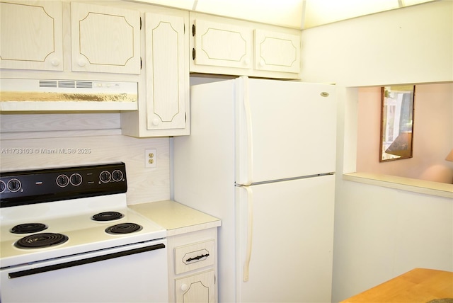 kitchen featuring electric stove and white fridge