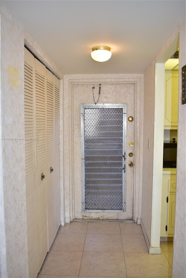 hall with light tile patterned floors