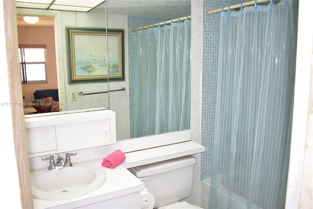 full bathroom featuring vanity, shower / bath combination with curtain, and toilet