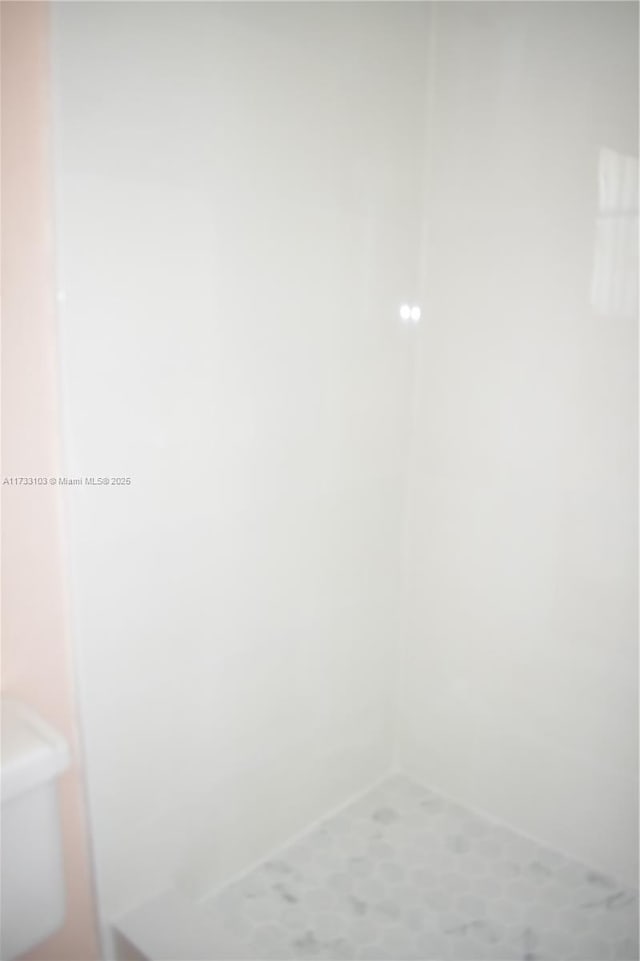 9360 Sunrise Lakes Blvd Unit 112, Sunrise, FL 33322 - bathroom featuring toilet and a shower