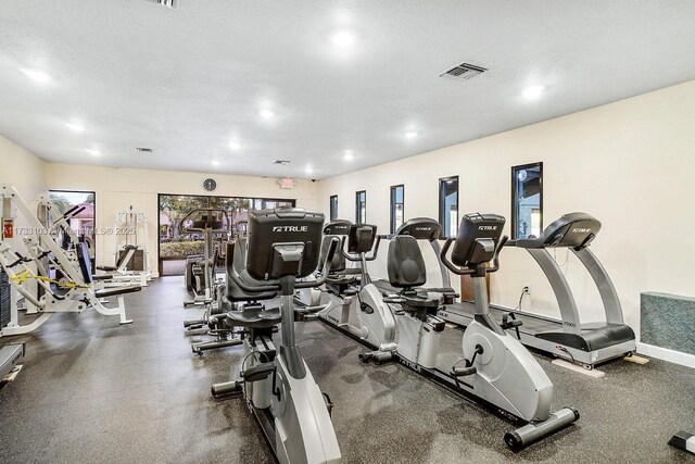 exercise room featuring a textured ceiling