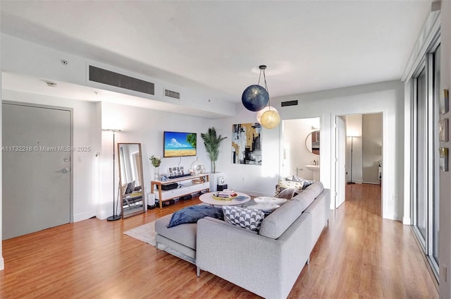 living room with light hardwood / wood-style flooring