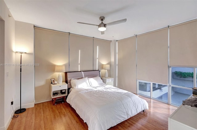 bedroom with ceiling fan, access to exterior, and light hardwood / wood-style floors