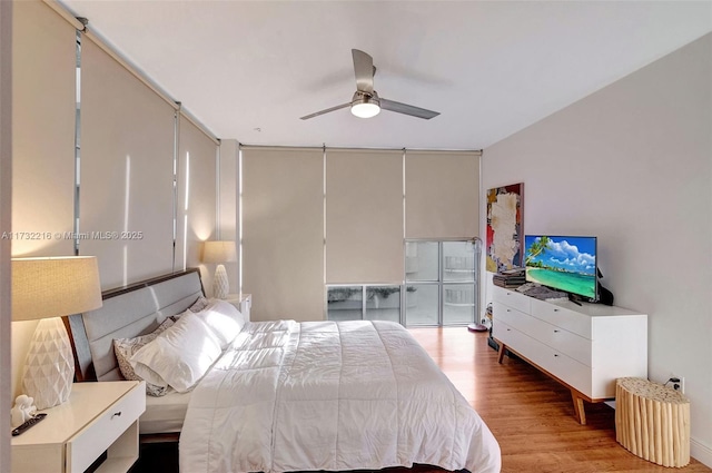 bedroom featuring hardwood / wood-style floors and ceiling fan