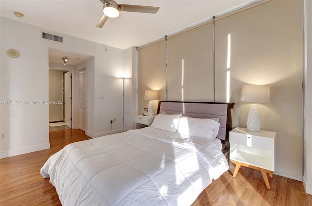 bedroom featuring ceiling fan, a closet, and light hardwood / wood-style flooring