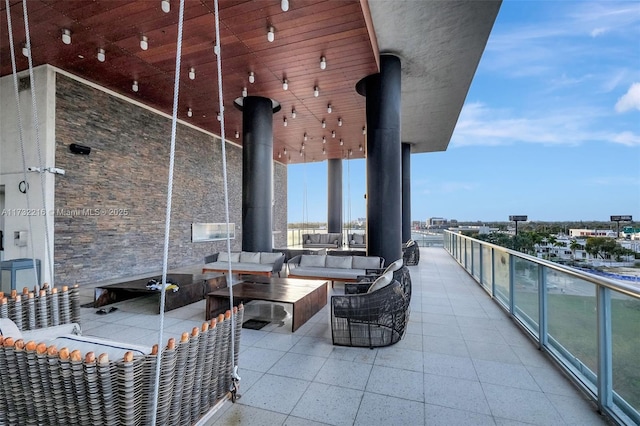 view of patio featuring an outdoor hangout area and a balcony