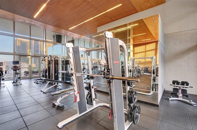 exercise room with wood ceiling and expansive windows