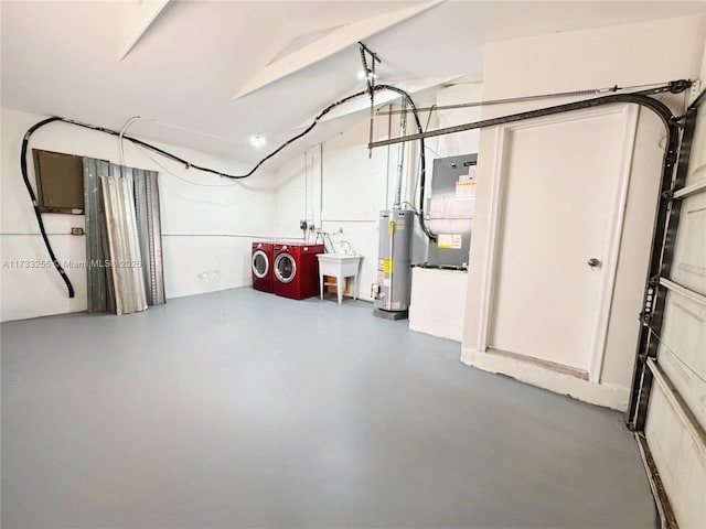 basement featuring sink, gas water heater, and washing machine and dryer