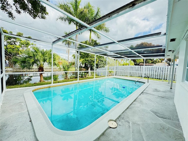 view of swimming pool with a patio and a lanai