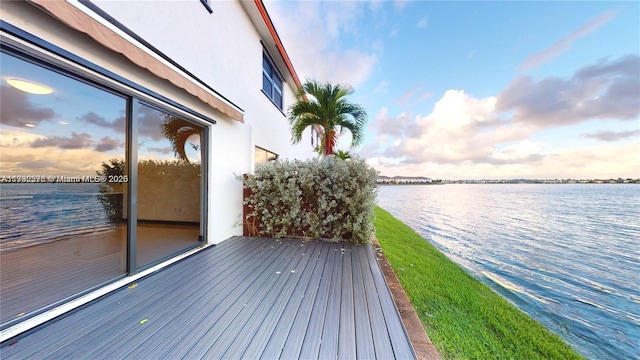 wooden deck featuring a water view