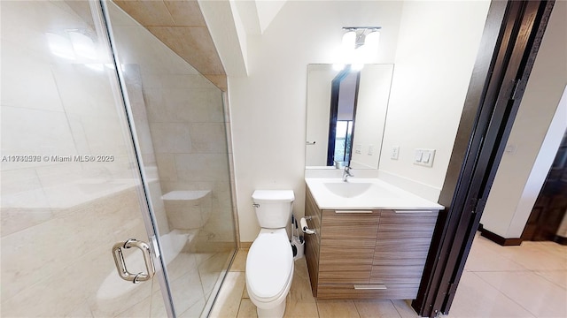 bathroom featuring vanity, tile patterned floors, a shower with door, and toilet