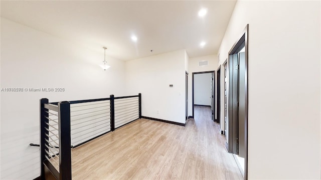 hall with light hardwood / wood-style floors