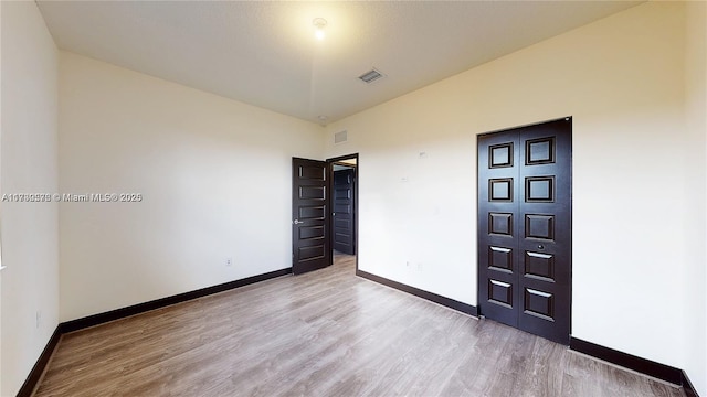 unfurnished bedroom with light wood-type flooring