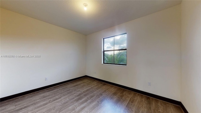 unfurnished room featuring hardwood / wood-style flooring