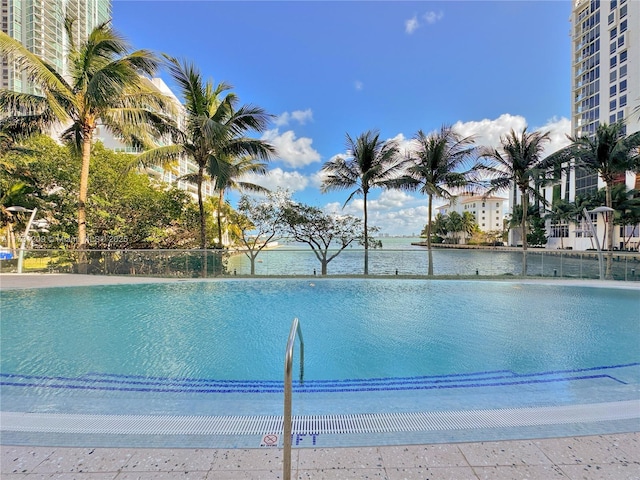 view of pool featuring a water view