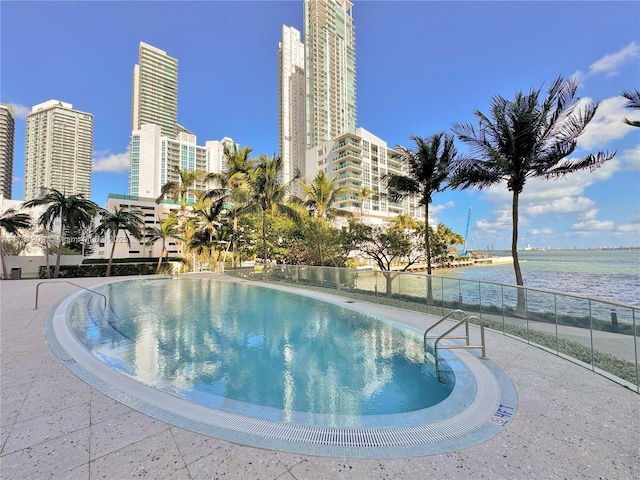 view of pool with a water view