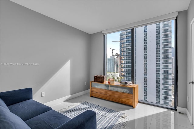 living area featuring floor to ceiling windows and light tile patterned flooring