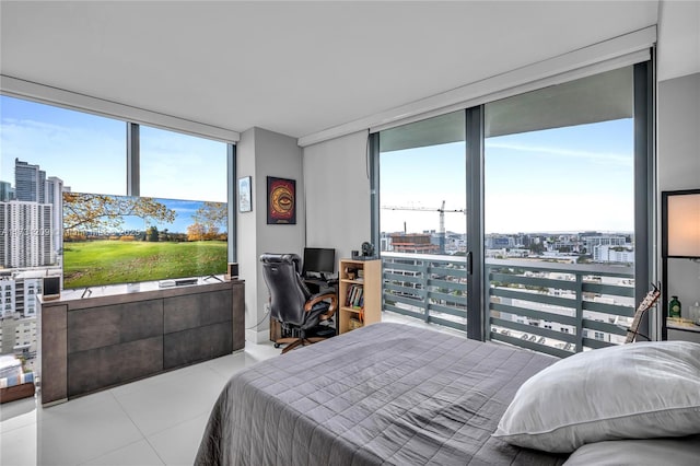 bedroom featuring expansive windows and tile patterned floors