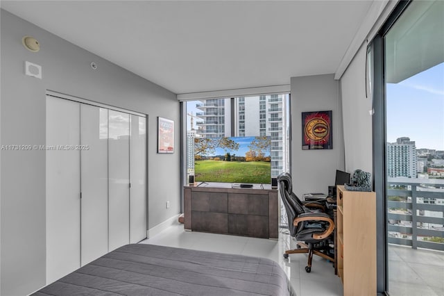 bedroom featuring floor to ceiling windows and a closet