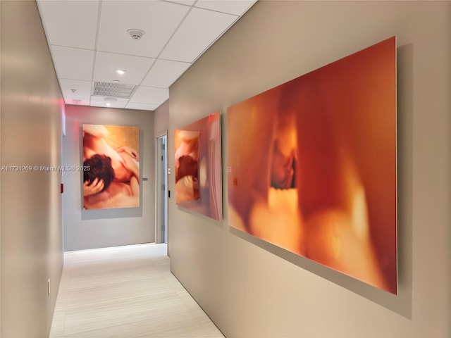 hallway featuring a paneled ceiling