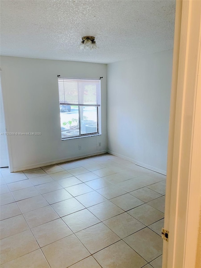 3360 N Pinewalk Dr N Unit 1315, Margate, FL 33063 - unfurnished room with light tile patterned flooring, a textured ceiling, and baseboards