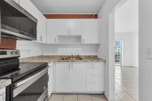 kitchen with appliances with stainless steel finishes, sink, white cabinets, ornamental molding, and light stone countertops