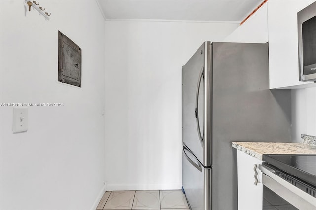 kitchen featuring crown molding and white cabinets