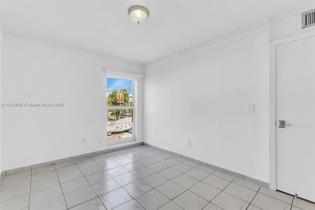 spare room featuring ornamental molding