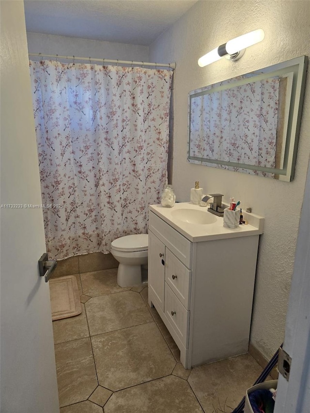 bathroom featuring vanity, curtained shower, and toilet