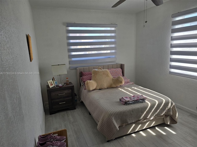 bedroom featuring hardwood / wood-style flooring and ceiling fan