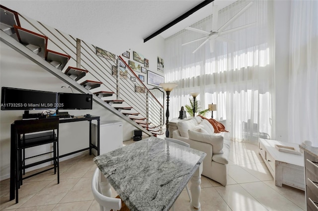 living room with light tile patterned flooring and ceiling fan