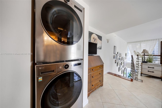 washroom with light tile patterned flooring and stacked washer and clothes dryer