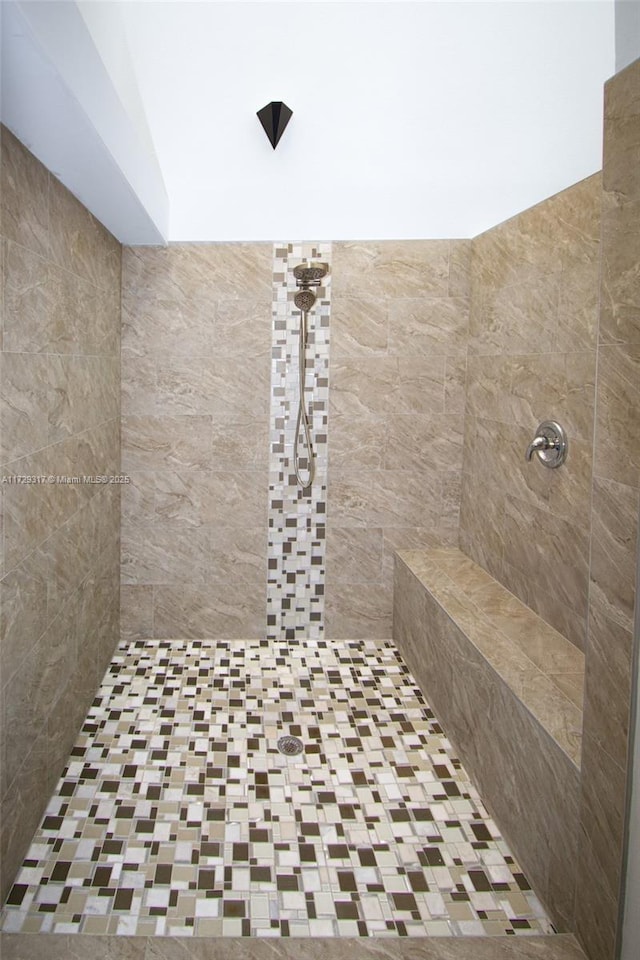 bathroom with a tile shower