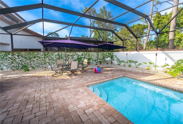 view of swimming pool with a lanai and a patio