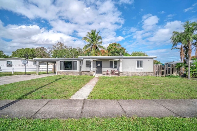 view of front of property with a carport and a front yard