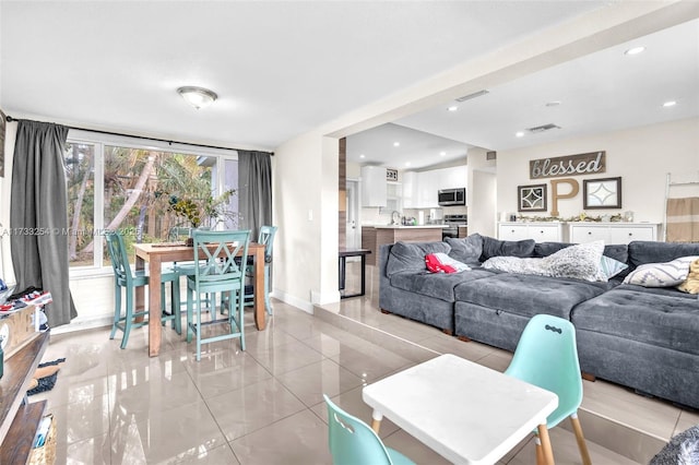 living room with light tile patterned floors and sink