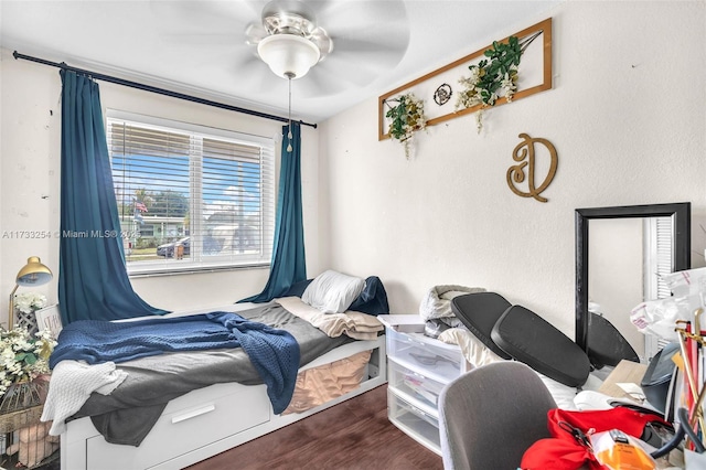 bedroom with ceiling fan and wood-type flooring