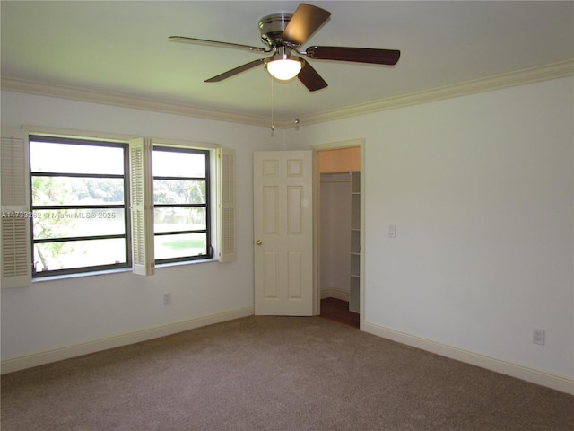 spare room with crown molding, ceiling fan, and carpet