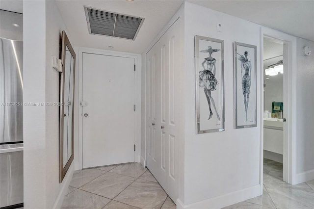 corridor with light tile patterned floors