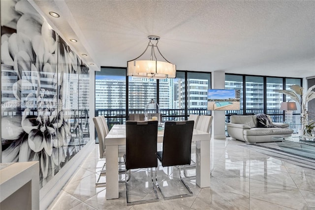 dining area with expansive windows, a notable chandelier, and a textured ceiling