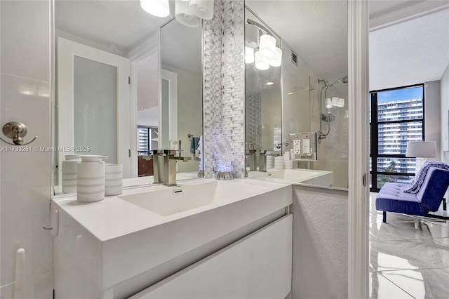 bathroom featuring vanity, floor to ceiling windows, and a shower