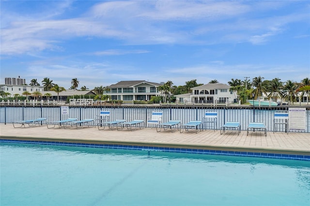 view of swimming pool featuring a water view