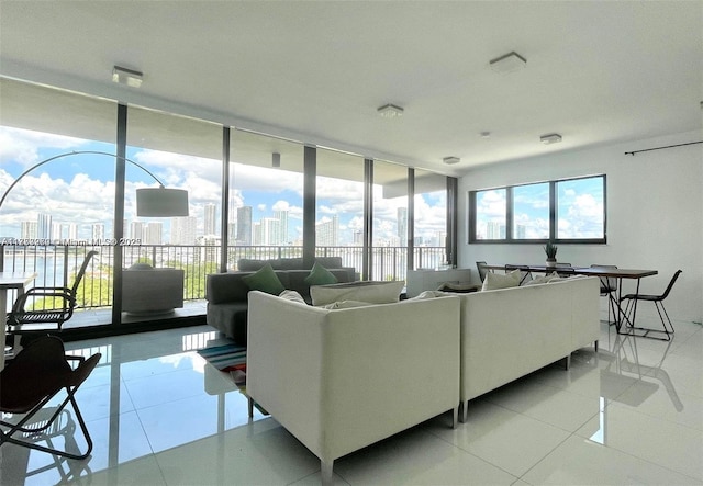 living room featuring light tile patterned flooring, a healthy amount of sunlight, and expansive windows