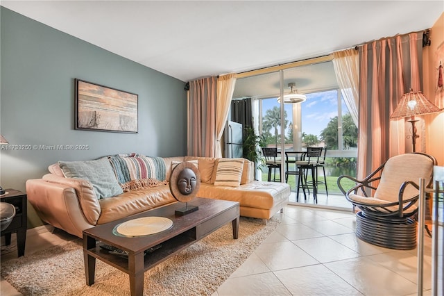 living room featuring a wall of windows and light tile patterned floors