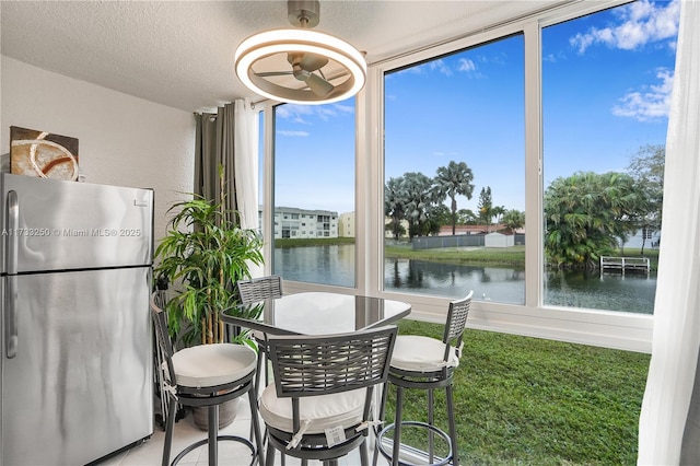 sunroom / solarium with a water view