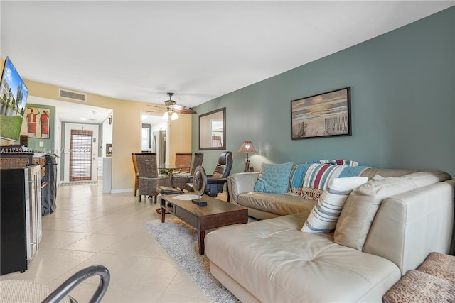 tiled living room featuring ceiling fan